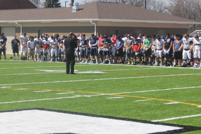 Fr. Chuck blesses field as football team gets first practice at St. Vincent's - Photos